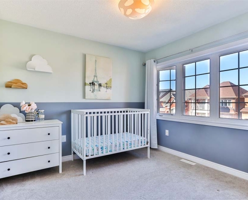 A room with baby furniture in it